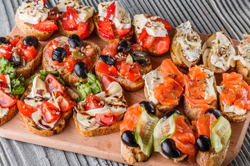 Assorted bruschetta Set of various appetizing snacks sandwiches