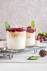 Dessert in glass with cream, muesli and berries
