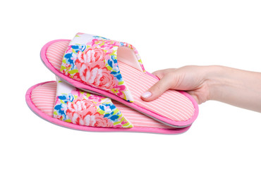 Female pink slippers in hand on white background isolation
