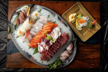 Sashimi from different types of fish on ice. Top view.