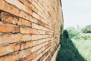 Diagonal corner of old red brick wall, wallpaper texture background