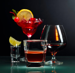 Various alcoholic drinks on a black background.