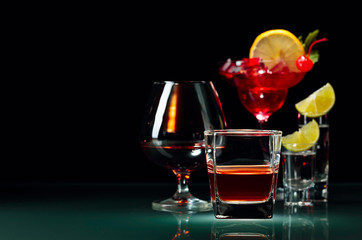 Various alcoholic drinks on a black background.
