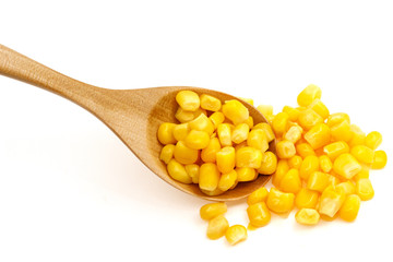 Corn seeds in a wooden spoon isolated on white background