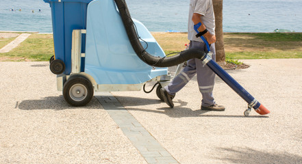 Konyaalti beach, Antalya, Turkey, vacuuming garbage