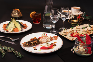 Tasty restaurant dishes: Cooked and stuffed crayfish, salad, appetizers, and crayfish ice-cream