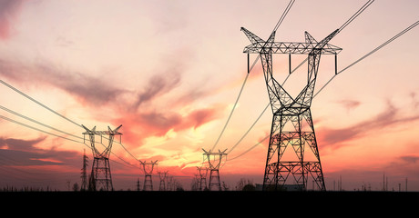Electricity pylons and lines at dusk. - 277397758