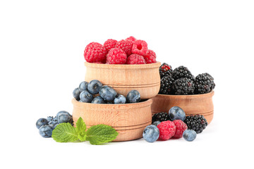 Wooden bowls with berries isolated on white background