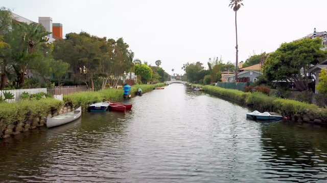 Dolly shot to the left over the Venice Canals day time, famous tourist destination in Los Angeles