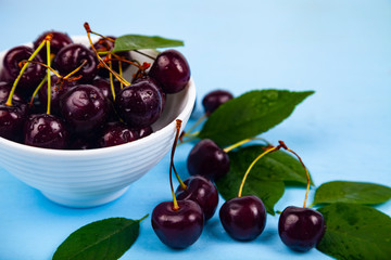 Ripe sweet cherry in a white bowl