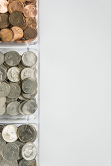 Organized loose coin change on left side, blank empty room space for text right