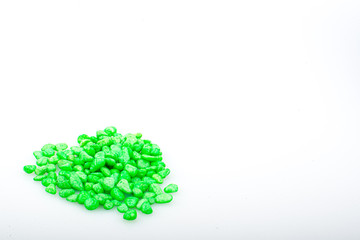 Green pebbles stone with empty copyspace area for slogan or advertising text message, over isolated white background.