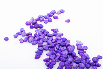 Purple pebbles stone with empty copyspace area for slogan or advertising text message, over isolated white background.