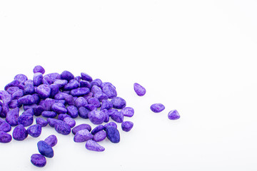 Purple pebbles stone with empty copyspace area for slogan or advertising text message, over isolated white background.