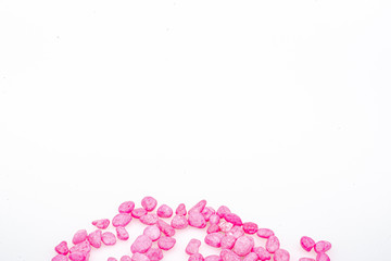 Pink pebbles stone with empty copyspace area for slogan or advertising text message, over isolated white background.