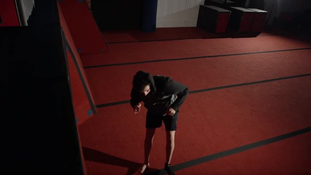Man training in parcour in the gym with padded equipment and obstacles