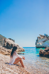 Fototapeta na wymiar Woman laying on the beach enjoying summer holidays looking at the sea