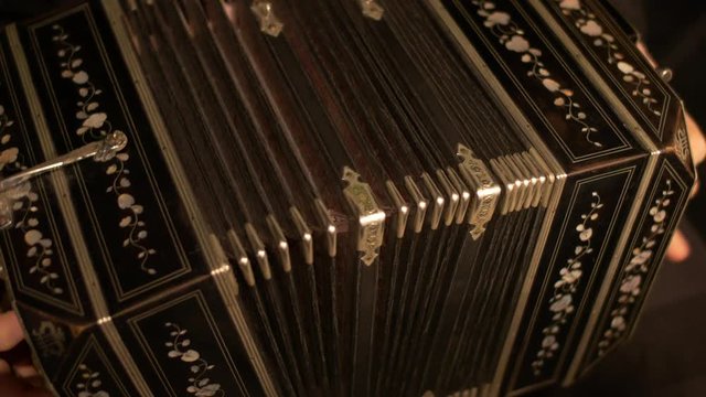 Close-up of a Bandoneon accordion, being played practicing for a tango music show.