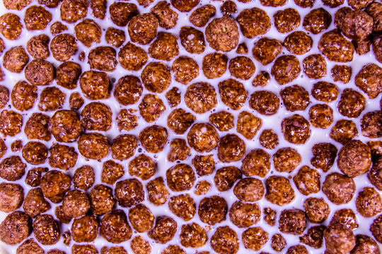 Texture of chocolate cereal balls in milk for the background