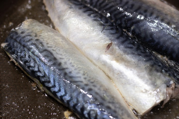 mackerel fish fried in pan oil thai style food. Mackerel fried in a black pan. Fish fried in a...