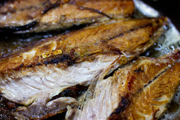 mackerel fish fried in pan oil thai style food. Mackerel fried in a black pan. Fish fried in a...
