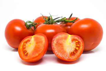 Red tomatoes on a branch. Vegetables isolated