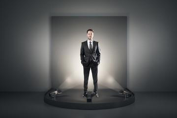 Fototapeta premium Attractive businessman on podium