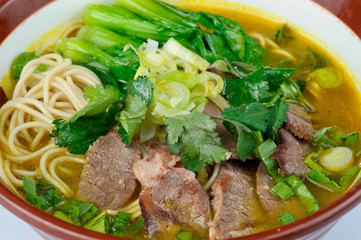 Close-up view at tasty and fresh Chinese noodles soup with meat and vegetables
