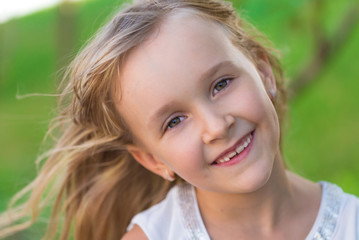 Fototapeta premium little girl face, green background, close up