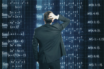 Businessman looking at formulas