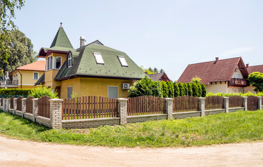 Houses surrounded by garden in Balatonlelle, Hungary in a sunny day.