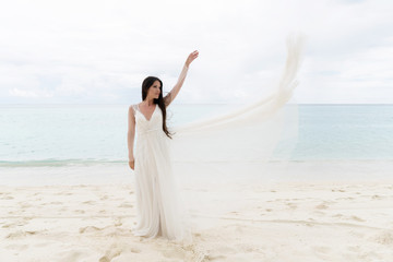 Fototapeta na wymiar The bride throws a white dress in the air.