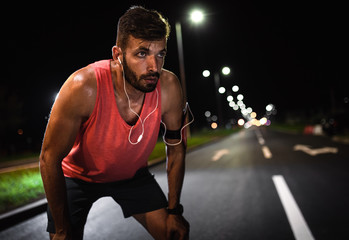 Man resting after night workout in the city.