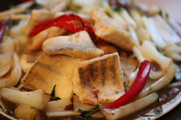 Fried pike perch with vegetables home-style.