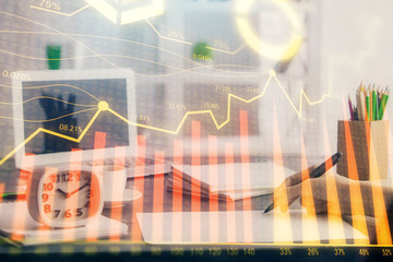 Fototapeta premium Financial graph displayed on woman's hand taking notes background. Concept of research. Multi exposure