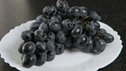 Blue bunch of grapes lying on a platter. 4K UHD 3840x2160 Video Clip