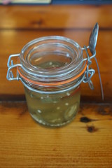 Glass Jar of Pickled Hot Peppers on a Restaurant Bar