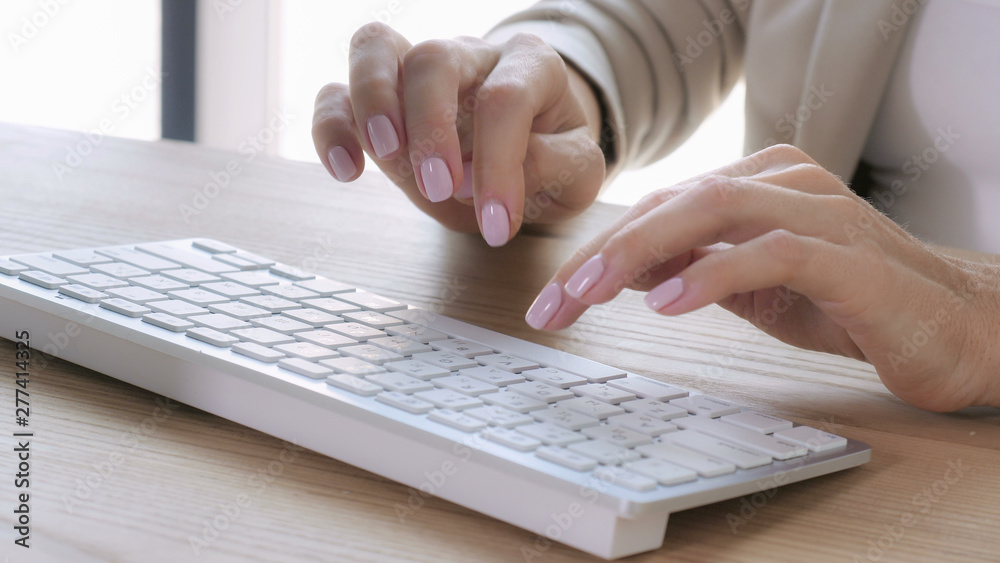 Poster close up details woman with elegant manicure typing on keyboard computer. female fingers fast enteri