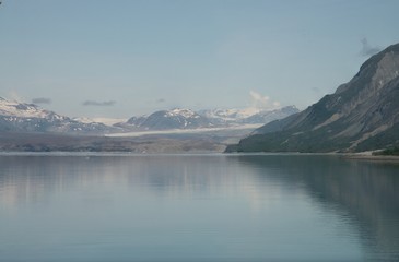 Reflection of rugged mountains in the still ocean water of Glacier Bay