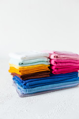 Pile of colorful textile swatches on white background
