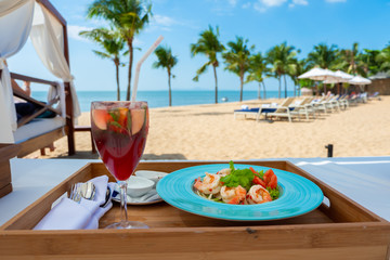 Spicy salad with glass noodle (Yum Woon Sen) and red sangria wine on beach background © arnonphoto