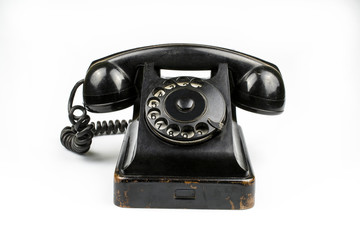 Shabby retro phone of black color isolated on a white background.