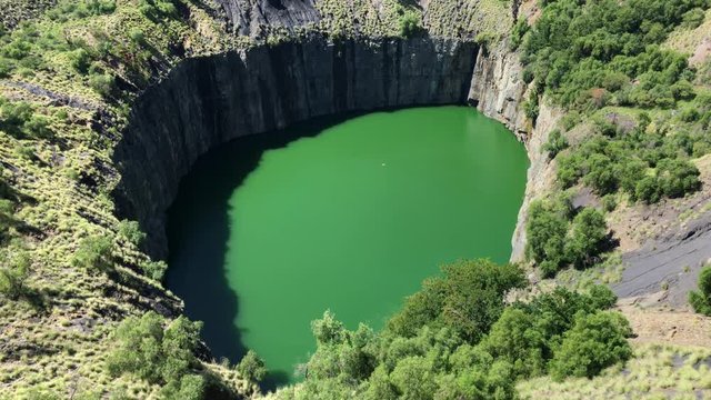 View of open pit mine that has filled up with water to form lake.