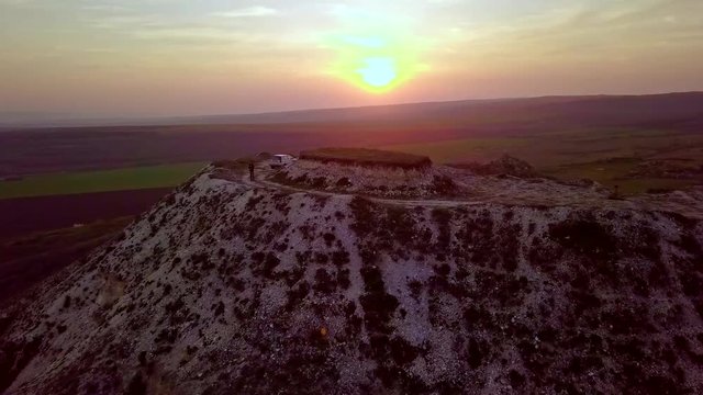 Sunset over hill with blue lake