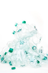 heap of empty crumpled plastic bottles on a white background