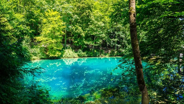 Germany, XXL nature landscape panorama of blue waters of natural spring, called blautopf (blue pot) in blaubeuren in swabian jura, a popular tourist destination