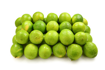 Many fresh limes on white background.