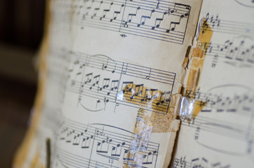 Old torn and repaired music notes