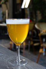 Famous Belgian beer served outside in small old cafe in special Belgian beer glass