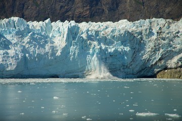 Chunk of Ice falling off Glacier, in Glacier Bay National Park and Preserve